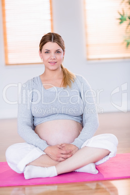 Pregnant woman looking at camera