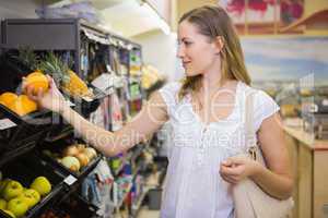 Smiling pretty blonde woman buying products