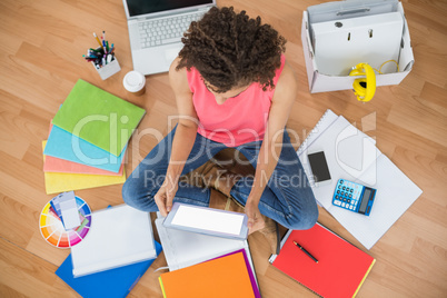 Young creative businesswoman working on tablet