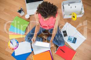 Young creative businesswoman working on tablet