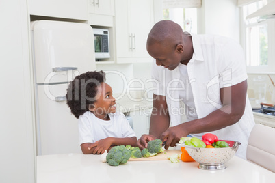 Little boy cooking with his father