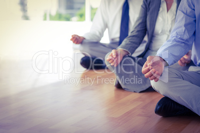 Close up view of business people doing yoga