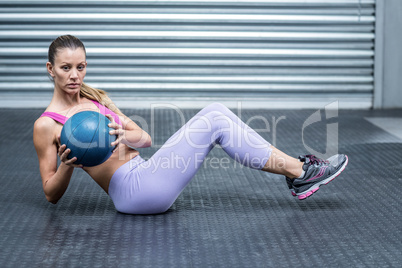 A muscular woman doing core exercises