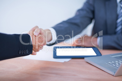 Two colleagues businessmen shaking hands