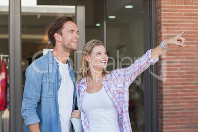 Happy couples looking and pointing far away