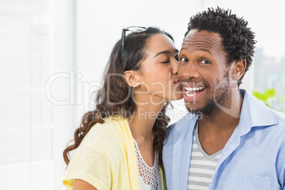 Portrait of a woman kissing her colleague