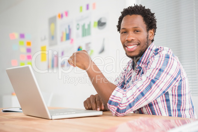 Young smiling businessman looking at the camera