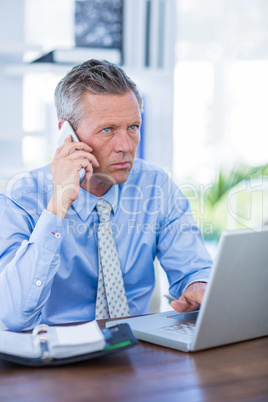 Serious businessman having phone call Serious businessman having phone call