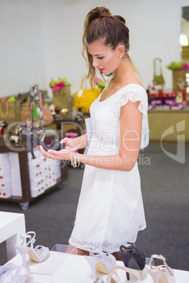 Smiling woman looking at high-heeled sandals