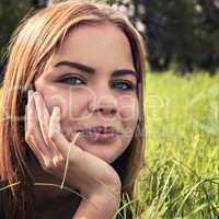 sensual young blonde lying on the grass outdoors