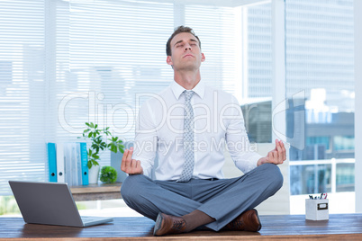 Zen businessman doing yoga meditation