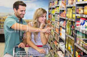 Smiling bright couple showing the shelf