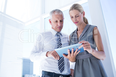 Business people discussing over a digital tablet