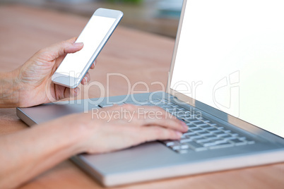 Close up view of hands typing on laptop