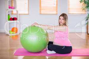 Pregnant woman doing exercise with exercise ball