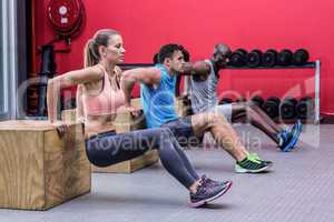 Muscular athletes doing reverse push up