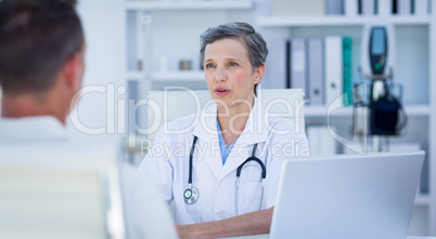 Female doctor speaking with her patient