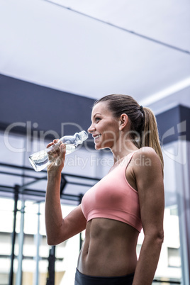 Young smiling Woman holding a bottle of water