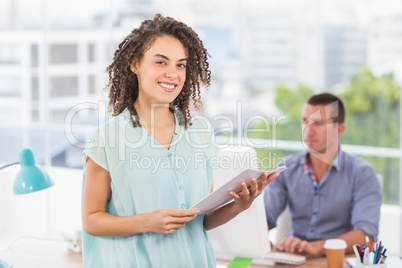 Smiling businesswoman holding a notebook