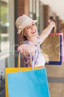 Carefree woman holding shopping bags