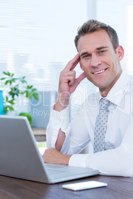 Smiling businessman looking at the camera