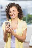 Smiling businesswoman watching her phone