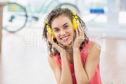 Young creative businesswoman enjoying music