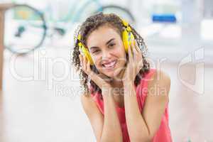 Young creative businesswoman enjoying music