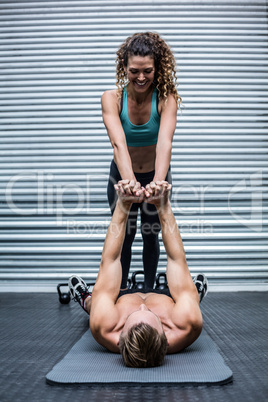 Muscular couple doing core exercises