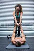 Muscular couple doing core exercises