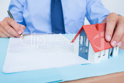 Businessman reading and writing a contrat before signing it
