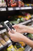 Woman buy products and using his smartphone