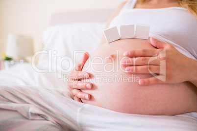 Pregnant woman with paper block on belly