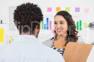 Young smiling business people talking to each other
