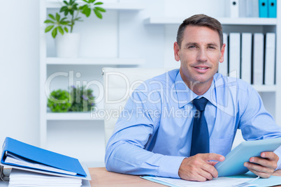 Portrait of smiling businessman using her digital tablet