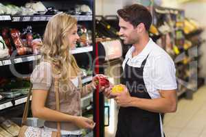 Smiling blonde woman buying a vegetables