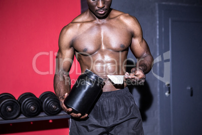 Young Bodybuilder filling his Bottle