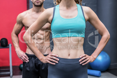 Muscular couple with hands on hips
