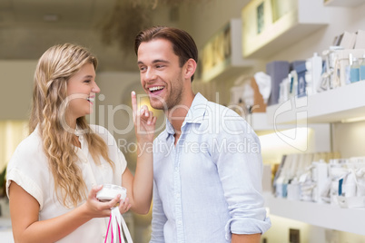 A couple testing a sample of beauty products
