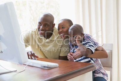 Happy smiling family chatting with computer