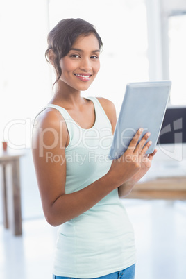 Casual brunette showing tablet computer