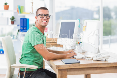 Young creative businessman typing on the computer