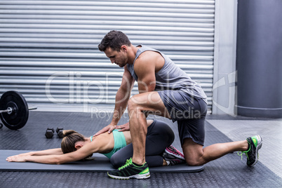 Muscular couple doing a body stretching