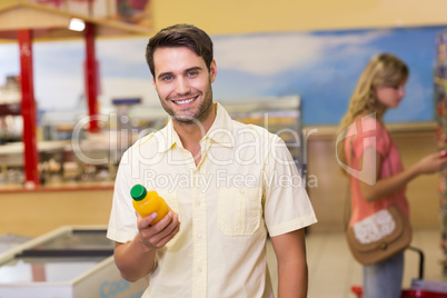 Portrait of a smiling handome man buying products