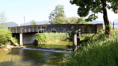 Bicyclists cross bridge in summertime