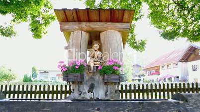 Beautiful Bavarian fountain with flowers in summer