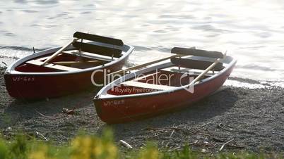 Rowing boats on the shore in evening sun