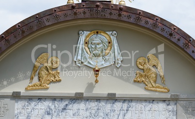 Lunette on Orthodox church with Christ's face and two angels