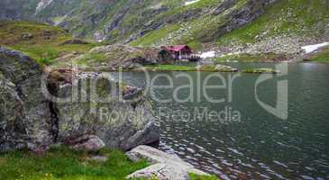 Idyllic view with typical lodge on Balea Lake