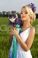 Beautiful bride blond blue eyes green field